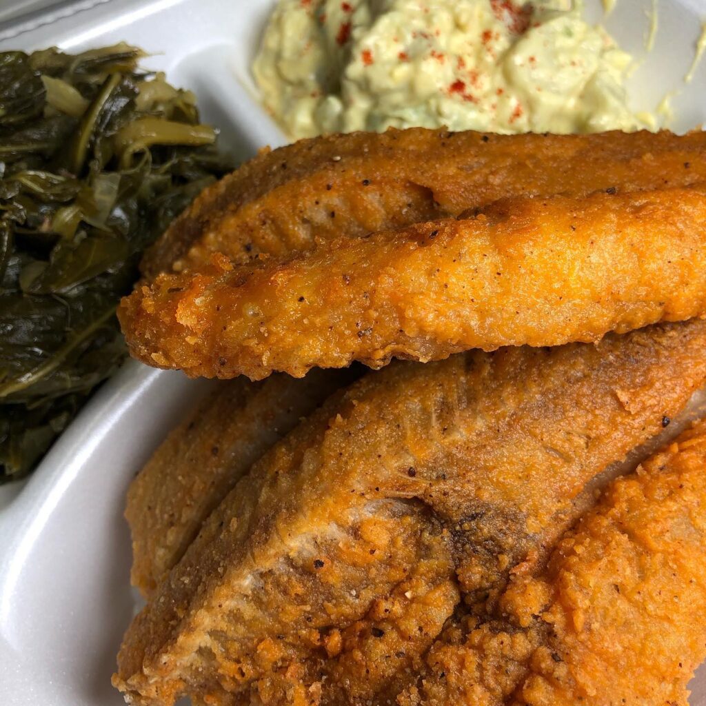 A plate of food with some meat and greens